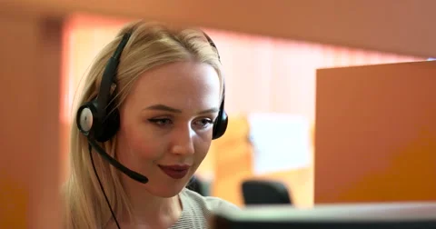Female receptionist working on computer and talking on the telephone in call 스톡 동영상 67106125