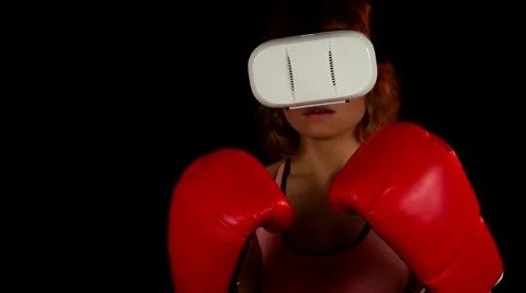 Female in the red boxing gloves invite to play in virtual reality video game Stock Footage 62343997