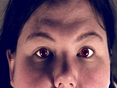 Female with red eyes Stock Footage 80175550