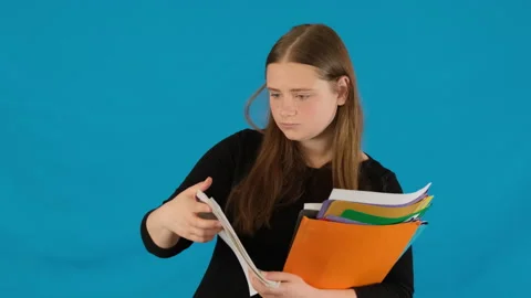 Female remains focused while folding documents into folder Stock Footage 316831207
