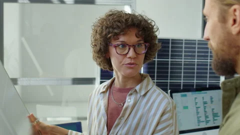 Female Renewable Energy Developer Discussing Solar Panel with Coworker Stock-Footage 230106128