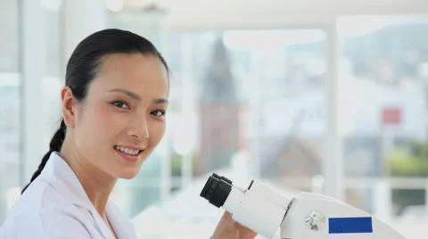 Female Researcher Looking Through Microscope In Laboratory Stock Footage 933712