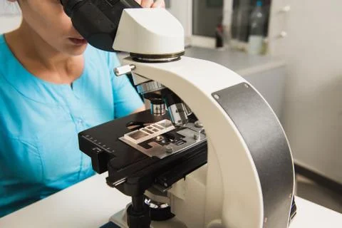 Female researcher with a microscope Stock Photos