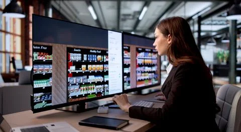Female Retail Manager Uses Computer Software To Plan Supermarket Shelf Layout Stock Photos