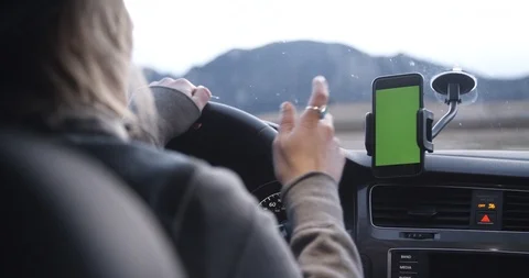 Female ride share driver accepts trip on phone app with car mount Stock Footage 88337494