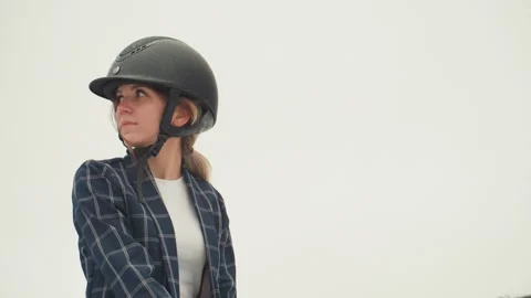 Female rider invokes elegance. Equestrian woman gazes across cloudy landscape Stock Footage 333311047