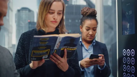 Female Riding Elevator Reading Book 스톡 동영상 167837484