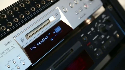 The female right hand inserts the disc into the mini disc player Stock Footage 77200519