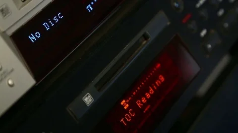 A female right hand inserts a disc into the mini disc player Stock Footage 78776265