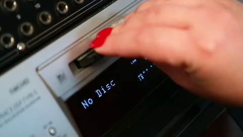 The female right hand presses the eject mini disc recorder button Stock Footage 77201018