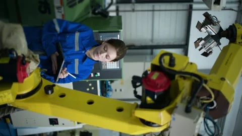 Female Robotics engineer working with Programming and Manipulating Robot Hand Stock Footage 280791157