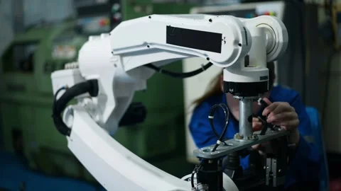 Female Robotics engineer working with Programming and Manipulating Robot Hand Stock Footage 280791194