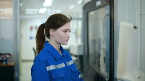 Female Robotics engineers Using Controller to Remotely Operate programming Stock Footage 280791119