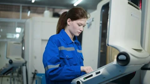 Female Robotics engineers Using Controller to Remotely Operate programming Stock Footage 280791150