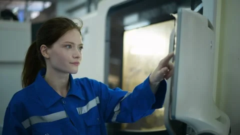 Female Robotics engineers Using Controller to Remotely Operate programming Stock Footage 280791160