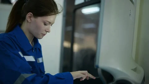 Female Robotics engineers Using Controller to Remotely Operate programming Stock Footage 280791167