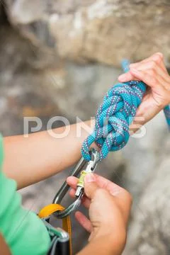 Female rock climber adjusting her harness Stock Photos