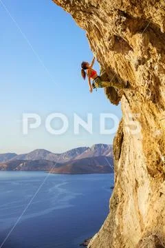 Female rock climber on challenging route Stock Photos