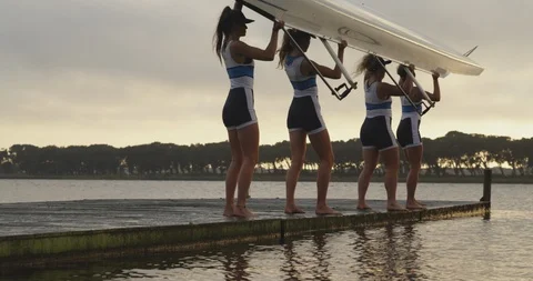 Female rowing team training on a river Stock Footage 116010941