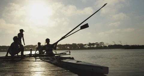 Female rowing team training on a river Stock Footage 116011062
