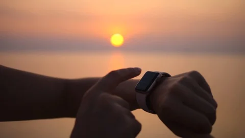 Female Runner Athlete Using Smart Watch App At Sunset Beach Stock Footage 93361438