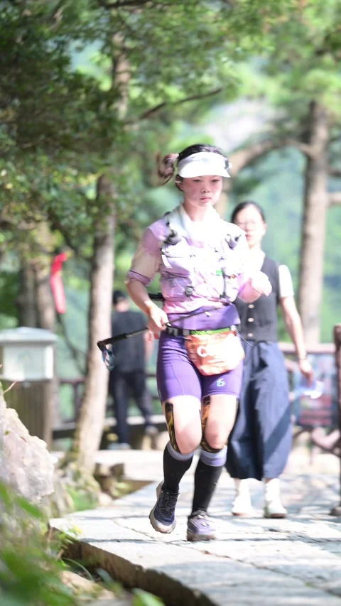 Female Runner with Braids in Purple Kit on Stone Trail, Lushan Stock Footage 346716586