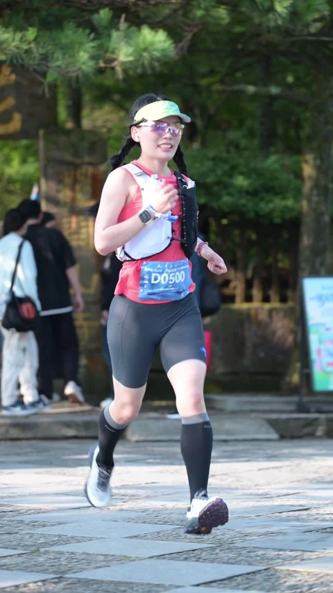 Female Runner with Braids in Red and Black Singlet on Stone Plaza, Lushan Stock Footage 346716252
