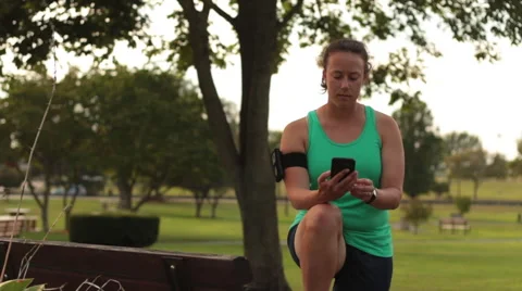Female Runner Checking Smart Phone Activity Tracker Vídeo Stock 54175608