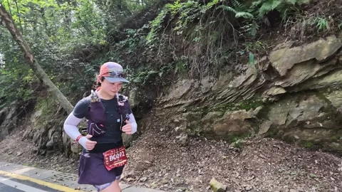 Female Runner in Dark Kit with Red Cap on Mountain Road, Lushan Stock Footage 346716112