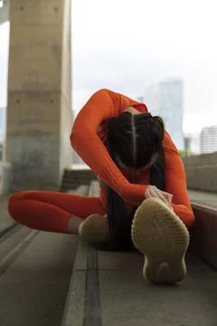 Female runner doing stretching exercise. Vertical image. Woman morning workou Stock Photos