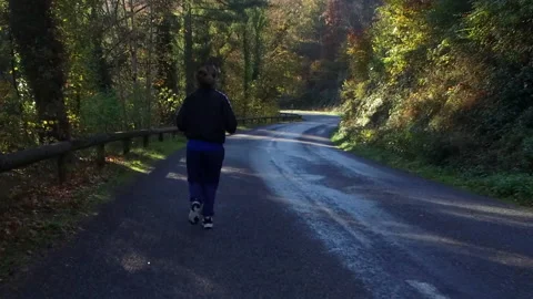 Female Runner on Forrest Road Stock Footage 142887109