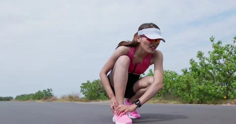 Female runner has ankle pain Stock Footage 165227828