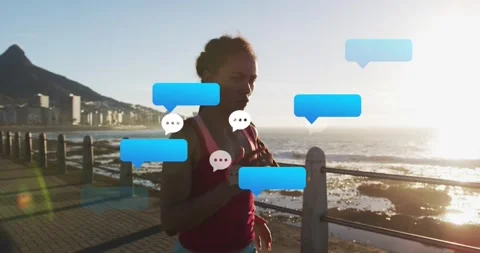 Female runner jogging coastal path, movement causing fitness app chat bubbles Stock Footage 331701353