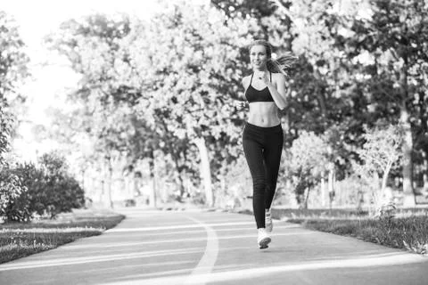 Female runner jogging in the forest Stock Photos