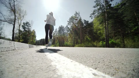 Female runner jogging on mountain road training for marathon. Stock Footage 62953993