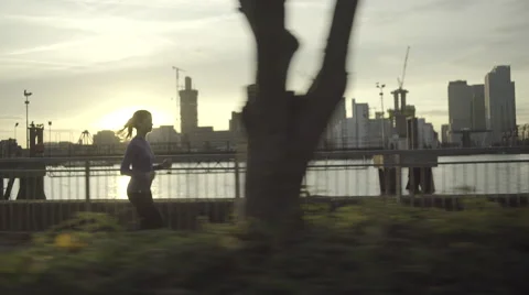 Female runner jogging by river Thames, London Stock Footage 56270441