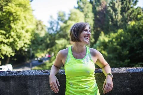 Female runner laughing while taking break while jogging in Seattle, Washington Stock Photos
