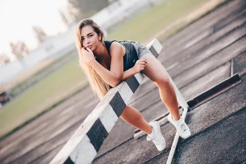 Female runner lay down to rest during morning workout Stock Photos