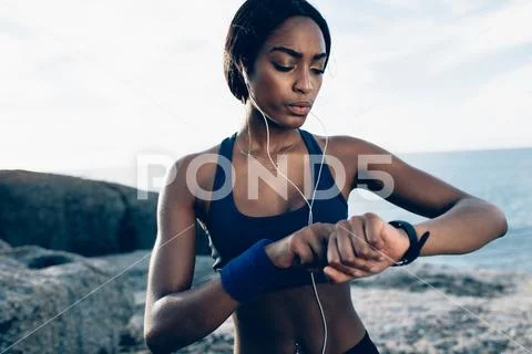 Female runner monitor her performance on smartwatch Stock Photos