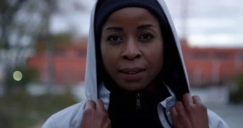 Female runner puts on hood Stock Footage 138455571