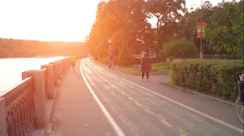 Female runner running at sunset in city park Stock Footage 64997464