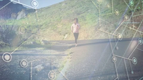 Female runner walking then jogging toward camera on hill road, with tech overlay Stock Footage 333594770