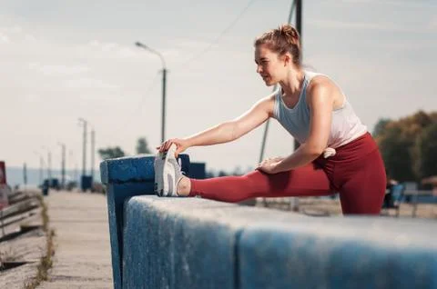 Female runner warming up at the beach Stock Photos