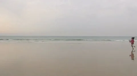 Female running on seashore Stock Footage 21925396