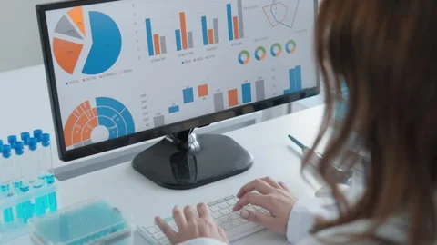 A female scientist analyzes laboratory data and statistics on a computer screen Stock Footage 340922298