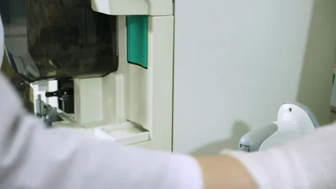 Female scientist analyzing sample of blood on modern equipment at laboratory. HD Stock-Footage 72237836