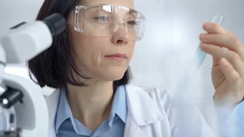 Female scientist analyzing sample in laboratory Stock Footage 277080958
