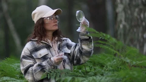 Female scientist biologist researcher testing seedling plant test tube lab Stock Footage 235671306