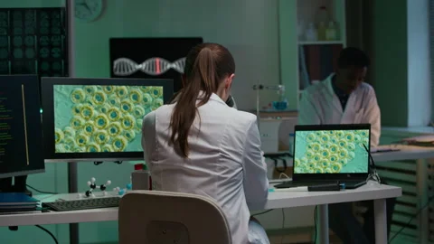 Female Scientist Decoding Genomic Sequences while Analyzing Cells in Lab Video stock 332359184