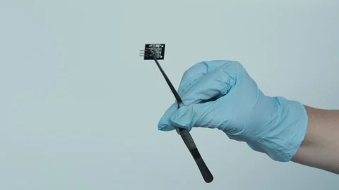 Female scientist, doctor holding microprocessor, microchip, biochip with tw.. Video stock 241214419